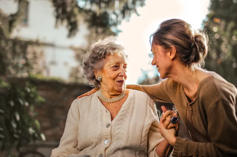 Adult daughter with her mother at home